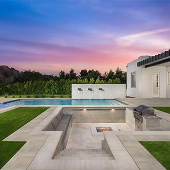 Outdoor living area finished with large-format stone tile
